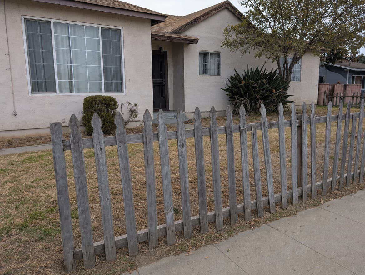 Old weathered wood fence before replacement